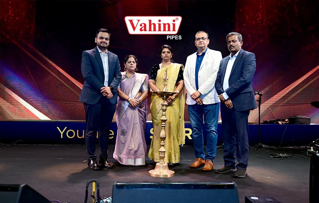 Five people on stage beside a traditional brass lamp, in front of a Vahini "You are the STAR" backdrop.