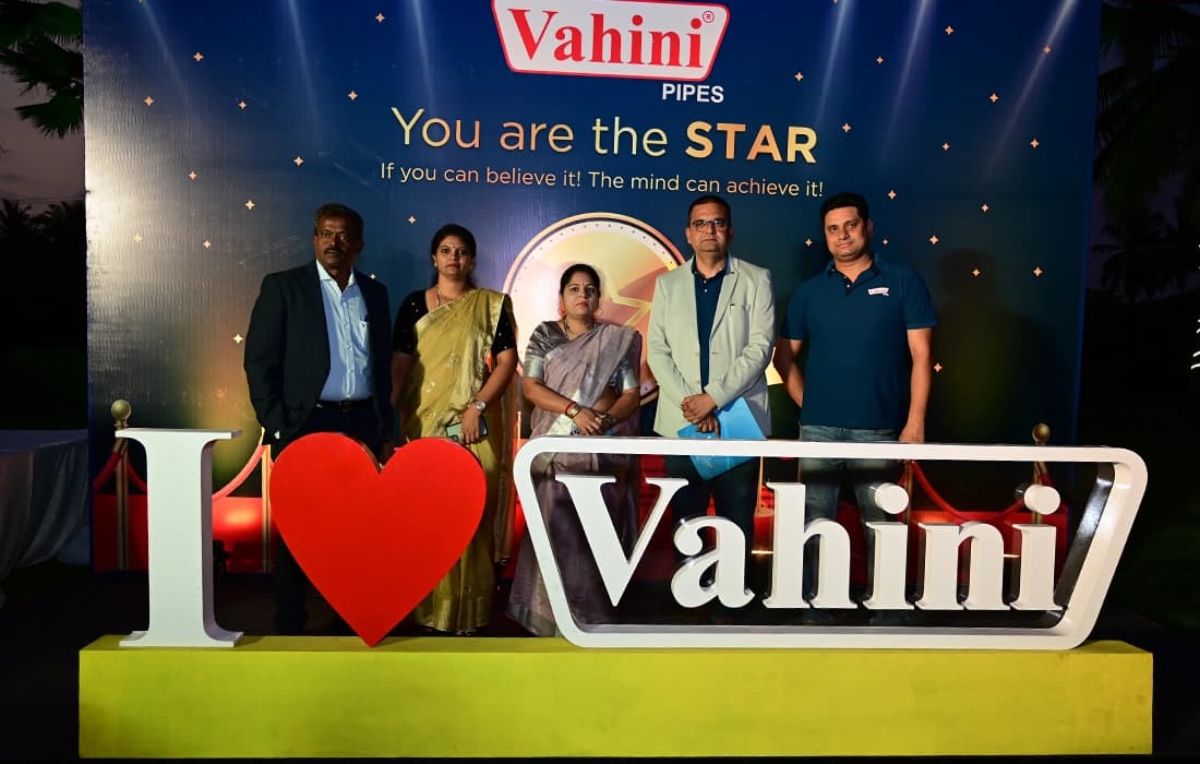 Six people standing behind an "I love Vahini" sign, in front of a "You are the STAR" backdrop.